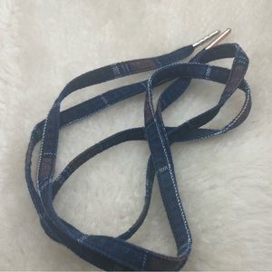 A pair of indigo plaid twill chow lace with mixed match tips